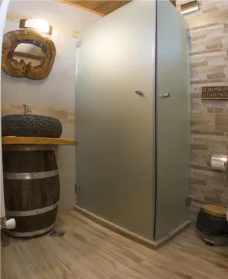 a bathroom with a refrigerator next to a barrel at Chateau Erkech Triple Room in Kozichino