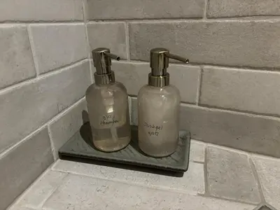 two bottles sitting on a shelf in a bathroom at Casa Mint in Sozopol