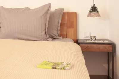 a bedroom with a bed with a book on it at Casa Mint in Sozopol