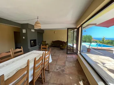 a dining room with a view of the ocean at Villa Alessandra in Emona