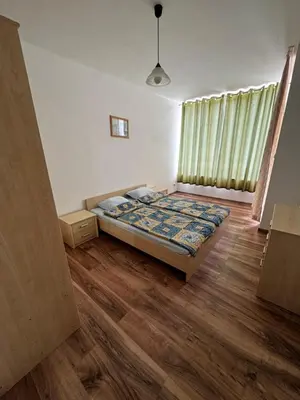 a bedroom with a bed and a wooden floor at 'Oasis' Ravda Apartment, Nessebar in Ravda