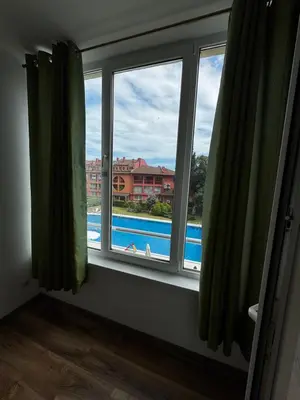 a room with a window with a view of a pool at 'Oasis' Ravda Apartment, Nessebar in Ravda