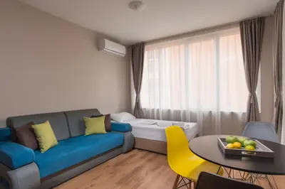 a living room with a couch and a table at Marina Bay Apartmant in Pomorie