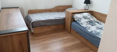 a small bedroom with two beds and a lamp at Стаи за гости Пансионът на Роуз Вълшебната ми Кръстница in Chernomorets