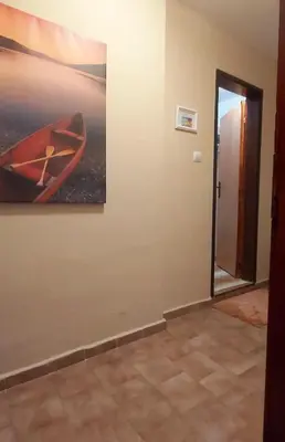 a room with a painting of a kayak on the wall at Stela in Burgas City