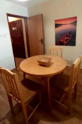a wooden table with chairs and a bowl on it at Stela in Burgas City