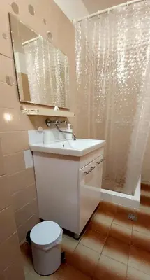 a bathroom with a sink and a toilet and a mirror at Stela in Burgas City