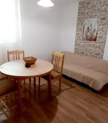 a small room with a table and a bed at Stela in Burgas City