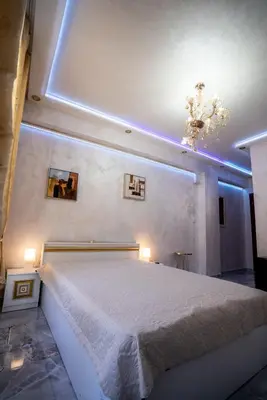 a bedroom with a large bed with lights on it at AR Luxury Apartments Ravda in Ravda