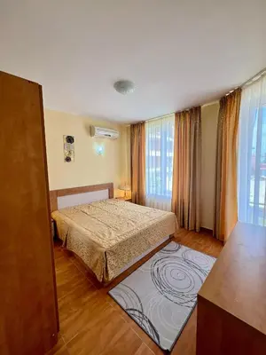 a bedroom with a bed and a large window at Panorama Dreams Apartment in Sveti Vlas