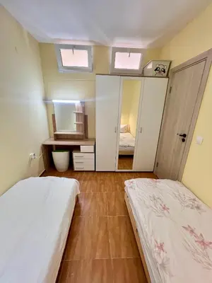 a bedroom with two beds and a mirror at Panorama Dreams Apartment in Sveti Vlas