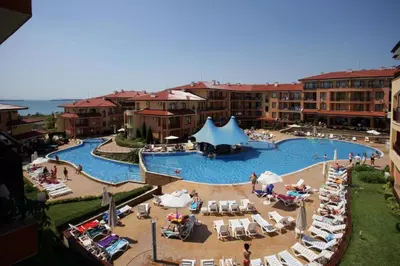 a large swimming pool with people in a resort at Panorama Dreams Apartment in Sveti Vlas