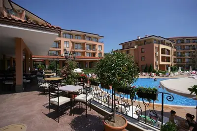 a patio with tables and chairs next to a swimming pool at Panorama Dreams Apartment in Sveti Vlas