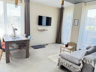 a living room with a table and a couch at Boho and More in Sozopol