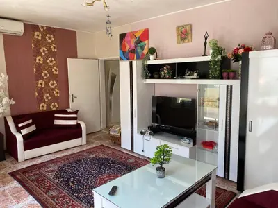 a living room with a couch and a tv at Centrum in Burgas City