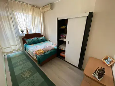 a small bedroom with a bed and a closet at Centrum in Burgas City