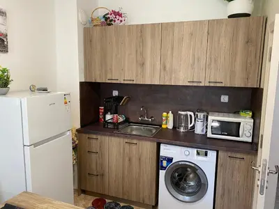 a small kitchen with a sink and a microwave at Centrum in Burgas City