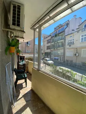 a balcony with a window with a view of a street at Centrum in Burgas City