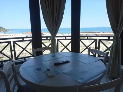 a table and chairs with a view of the beach at Oasis Beach 2 bedroom apartment in Lozenets