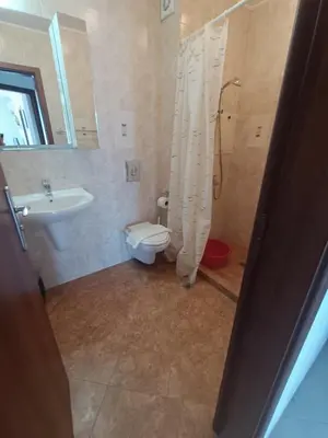 a bathroom with a shower and a toilet and a sink at Oasis Beach 2 bedroom apartment in Lozenets
