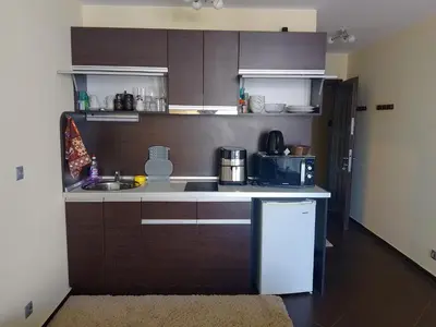a small kitchen with a sink and a refrigerator at Studio 41 in Ravda