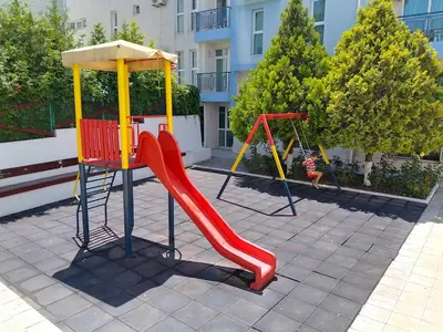 a playground with a red slide at Studio 41 in Ravda