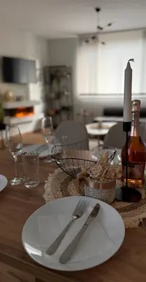 a table with a white plate and fork and knife at Goldy central beach apartment with private garden Burgas in Burgas City