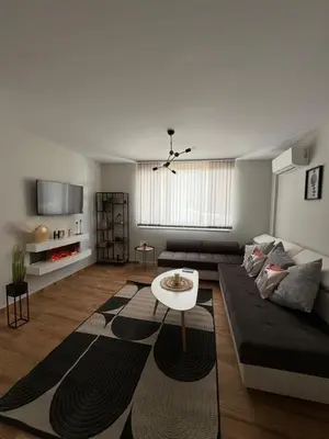 a living room with a couch and a table at Goldy central beach apartment with private garden Burgas in Burgas City