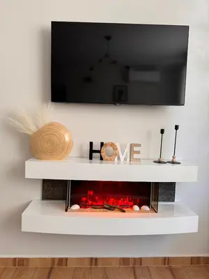 a white fireplace with a tv above it at Goldy central beach apartment with private garden Burgas in Burgas City