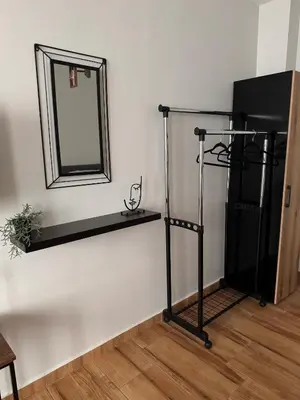 a mirror on a wall next to a shelf at Goldy central beach apartment with private garden Burgas in Burgas City
