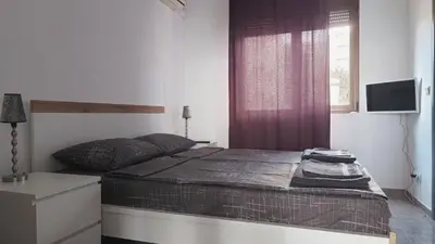 a bedroom with a bed and a window and a television at Dolce Vita 1 Infinity Love in Sveti Vlas