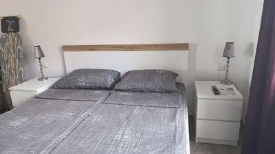 a bedroom with a bed with two pillows and two night stands at Dolce Vita 1 Infinity Love in Sveti Vlas