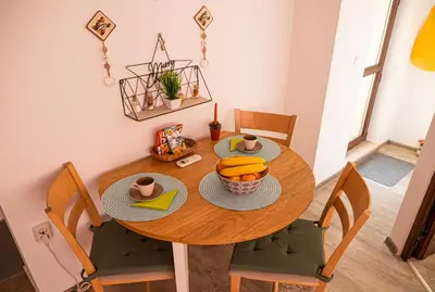 a dining room table with a bowl of fruit on it at Cozy 1-bedroom apartment 5 min from the beach in Varna City