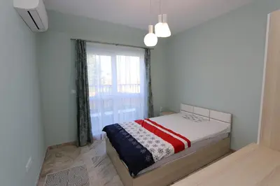 a bedroom with a bed and a large window at Panoramic Penthouse Apartment in Varna City