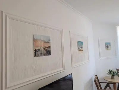 a room with three pictures on the wall at KAYA Atelie 1 Sunny Beach in Sunny Beach