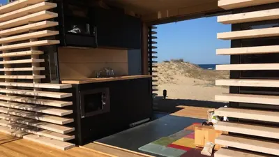 a room with a kitchen with a view of the beach at Firstline Beach Camp in Sozopol