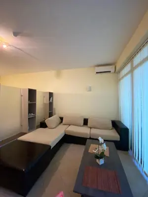 a living room with a couch and a table at Central Beach Apartament in Sunny Beach