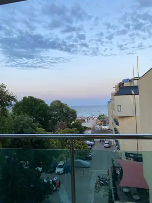 a balcony with a view of a parking lot and the ocean at Central Beach Apartament in Sunny Beach