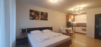a bedroom with a bed with towels on it at Central Beach Ravda Apartments in Ravda