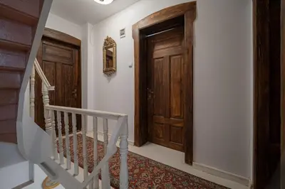 a hallway with a wooden door and a staircase at Beehive Hotel and CoWorking in Varna City
