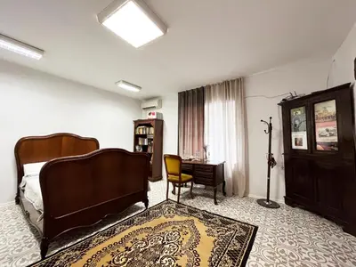 a bedroom with a bed and a desk and a chair at Beehive Hotel and CoWorking in Varna City