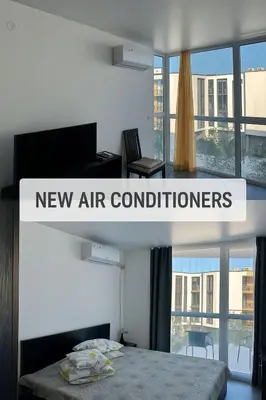 a new air conditions sign in a room with a bed at Atlantis Resort & 4 swimming pools & Spa & Апартамент in Burgas City