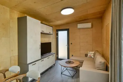 a living room with a couch and a table at Holiday Village Smokinia in Sozopol