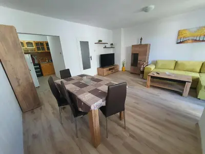 a living room with a table and chairs and a couch at Apartament Lazur 13 in Burgas City