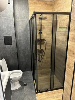 a shower stall in a bathroom with a toilet at Апартамент - Весела улица in Sozopol