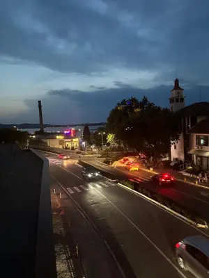 a city street with cars on the road at night at Апартамент - Весела улица in Sozopol