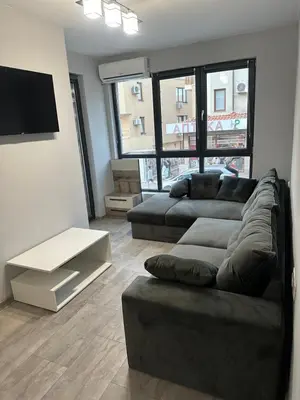 a living room with a couch and a flat screen tv at Апартамент - Весела улица in Sozopol
