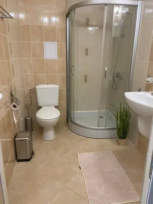 a bathroom with a shower and a toilet and a sink at JOY Studio in Ravda