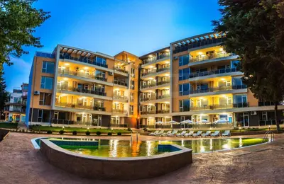 a large building with a fountain in front of it at JOY Studio in Ravda