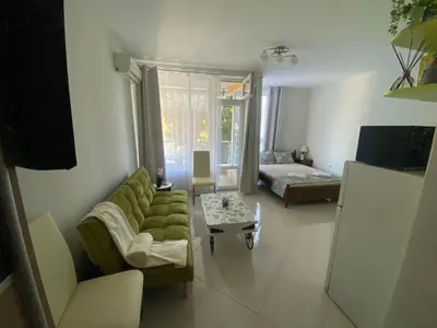 a living room with a couch and a table at JOY Studio in Ravda